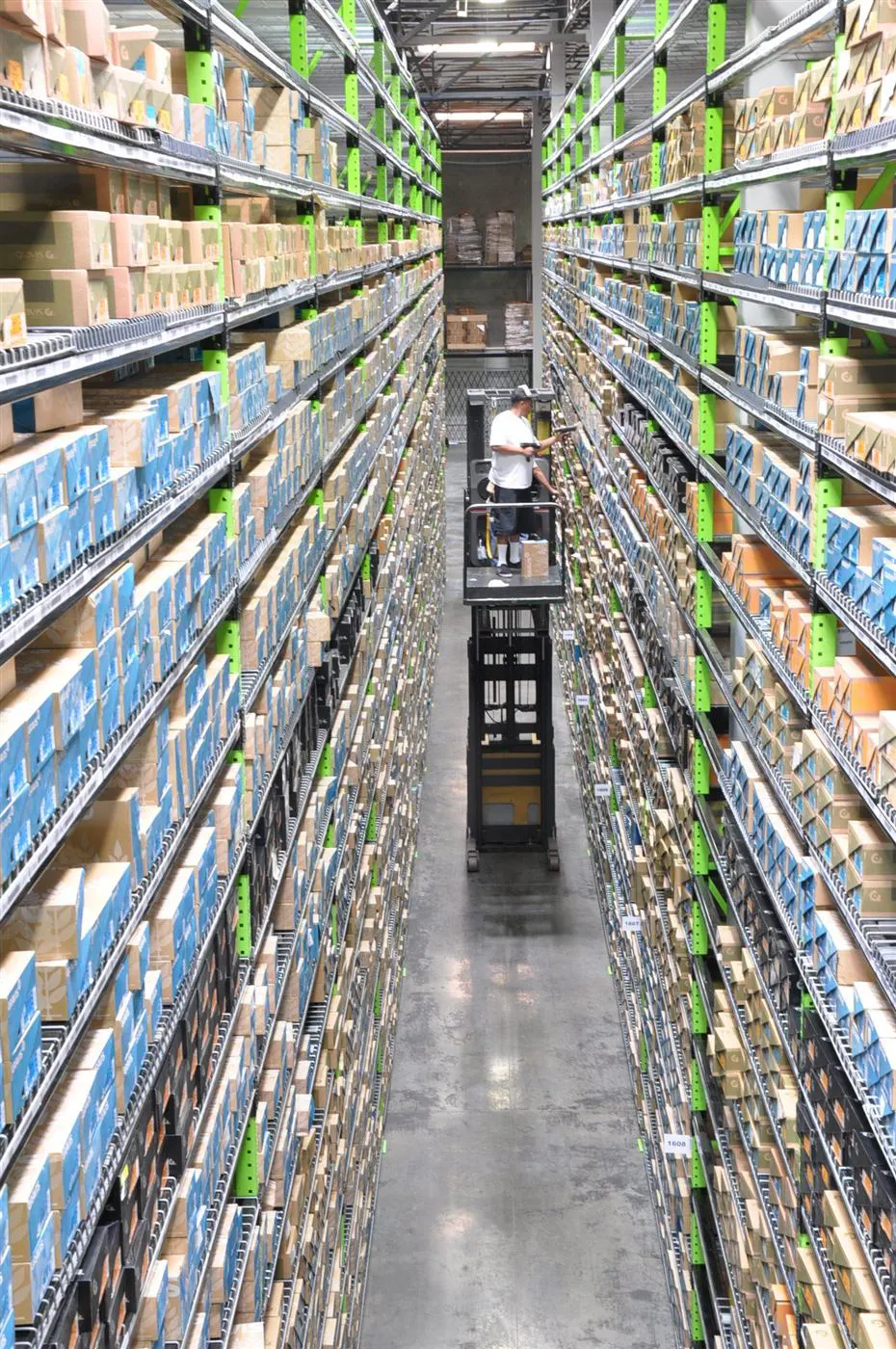 Towering aisles of barcoded shelving inside the Brand Warehouse fulfillment center