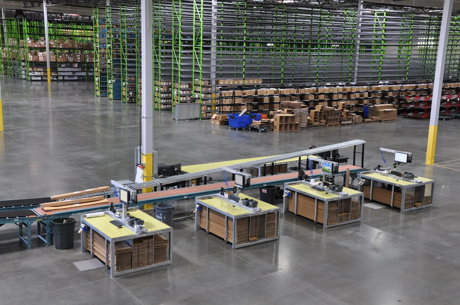 Packing stations and conveyor lanes on the Brand Warehouse fulfillment floor